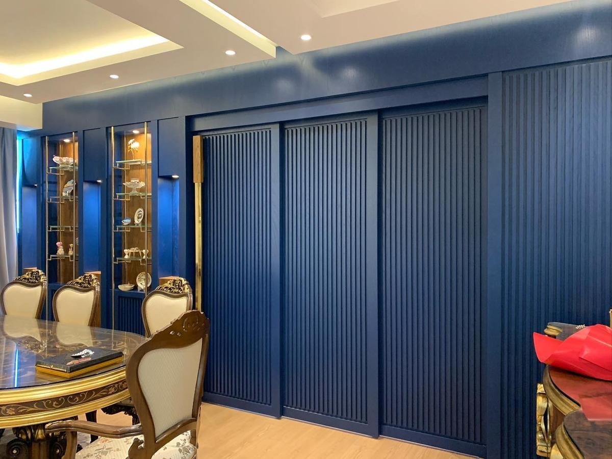 Master bedroom with full-height upholstered wardrobe wall and mirror panels
